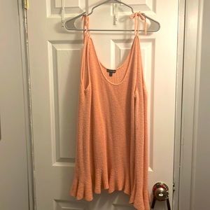 Lightweight peach colored off the shoulder sweater. Has ties on shoulder.